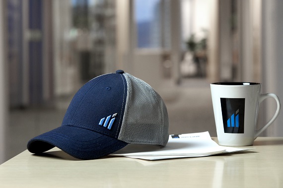 Incline Equity hat and coffee mug sitting on table