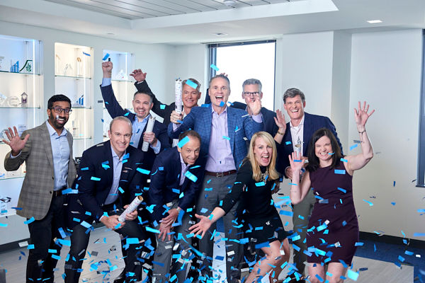 business men and women celebrating with confetti