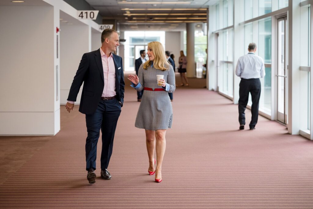 man and woman walking and talking