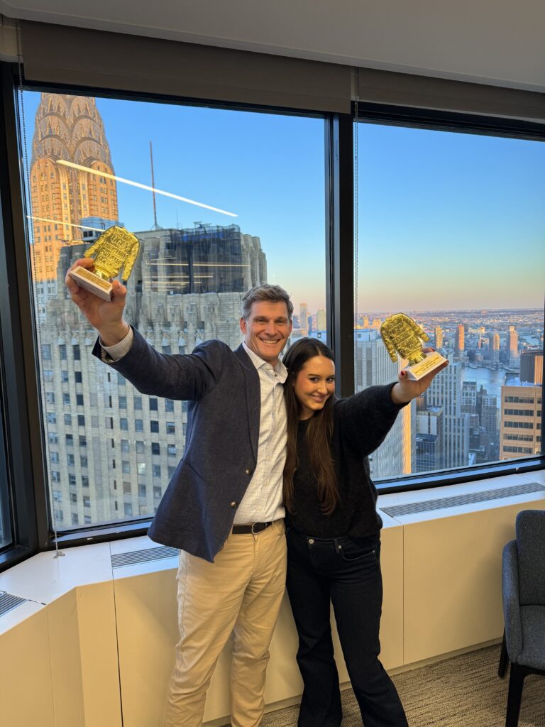 a man and woman holding trophies out for a picture