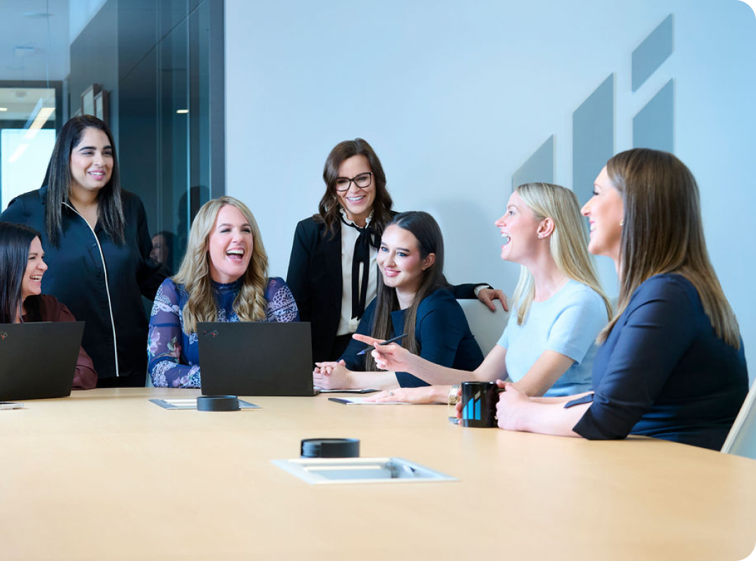 women sitting around table laughing