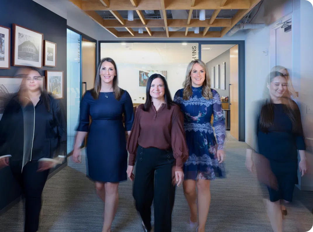 Women walking down the hall smiling