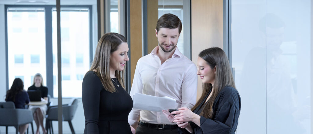 Team discussing paperwork