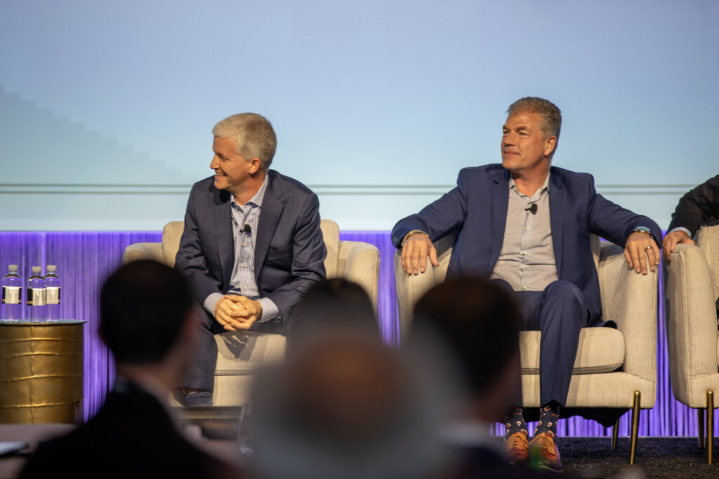 Two men on stage doing a presentation